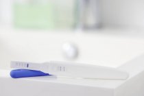 Pregnancy test showing positive result on table. — Stock Photo