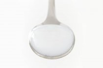 Milk of magnesia on spoon, studio shot. — Stock Photo