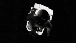 Illustration of astronaut in white spacesuit flying in shadow in space. — Stock Photo