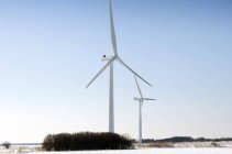 Wind turbines in snowy winter landscape under blue sky in Esbjerg, Denmark. — Stock Photo
