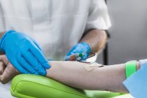 Close-up of doctor drawing female patient blood for PRP cosmetics treatment. — Stock Photo