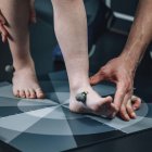 Physical therapist placing reflective marking balls for gait analysis. — Stock Photo