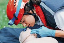 Female paramedic practicing mouth-to-mouth while CPR training outdoors. — Stock Photo