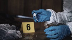Forensics expert collecting blood sample from crime scene. — Stock Photo