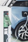 Close-up of electric vehicle charging station device and cable of car. — Stock Photo