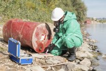 Pollution control inspector taking sample at pollution site. — Stock Photo
