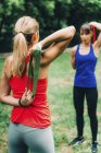 Women exercising with elastic bands in green park. — Stock Photo