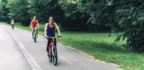 Due donne medie adulte in bicicletta insieme nel parco
. — Foto stock