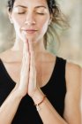 Portrait of serene young woman in namaste prayer position. — Stock Photo