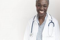 Mature female doctor smiling and looking in camera. — Stock Photo