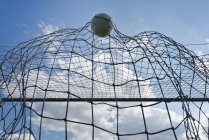 Ball entering net in soccer match, low angle view. — Stock Photo