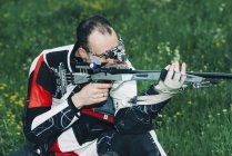 Mid adult man practicing sports rifle shooting. — Stock Photo