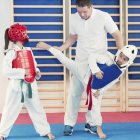 Instructor explaining kicking technique for children in class. — Stock Photo