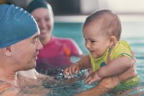 Father with baby boy in public swimming pool. — Stock Photo