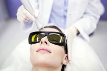 Beauty technician using laser treatment. — Stock Photo