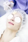 Dermatologist cleaning face after microdermabrasion treatment in clinic, close-up. — Stock Photo