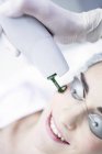 Dermatologist using laser welder machine on female face, close-up. — Stock Photo