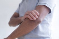 Man touching elbow in pain, close-up. — Stock Photo