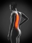 Seitenansicht des männlichen Körpers mit Rückenschmerzen auf schwarzem Hintergrund, konzeptionelle Illustration. — Stockfoto
