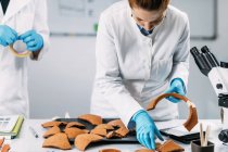 Archaeologists reconstructing broken pottery in laboratory. — Stock Photo