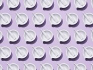 Pestles and mortars in rows, pharmacy pattern on violet background. — Stock Photo