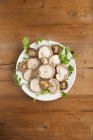 Top view of plate of shiitake mushrooms and herbs. — Stock Photo