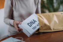 Mujer mayor preparando kit de prueba de ADN . - foto de stock