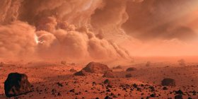 Огромная пыльная буря появляется над кратером на Марсе. Марс является четвертой планетой в нашей Солнечной системе, и предметом большего количества космических миссий, чем любой другой мир — стоковое фото