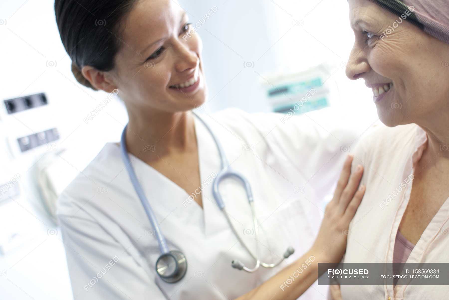 Nurse comforting female chemotherapy patient. — hospital, nursing ...