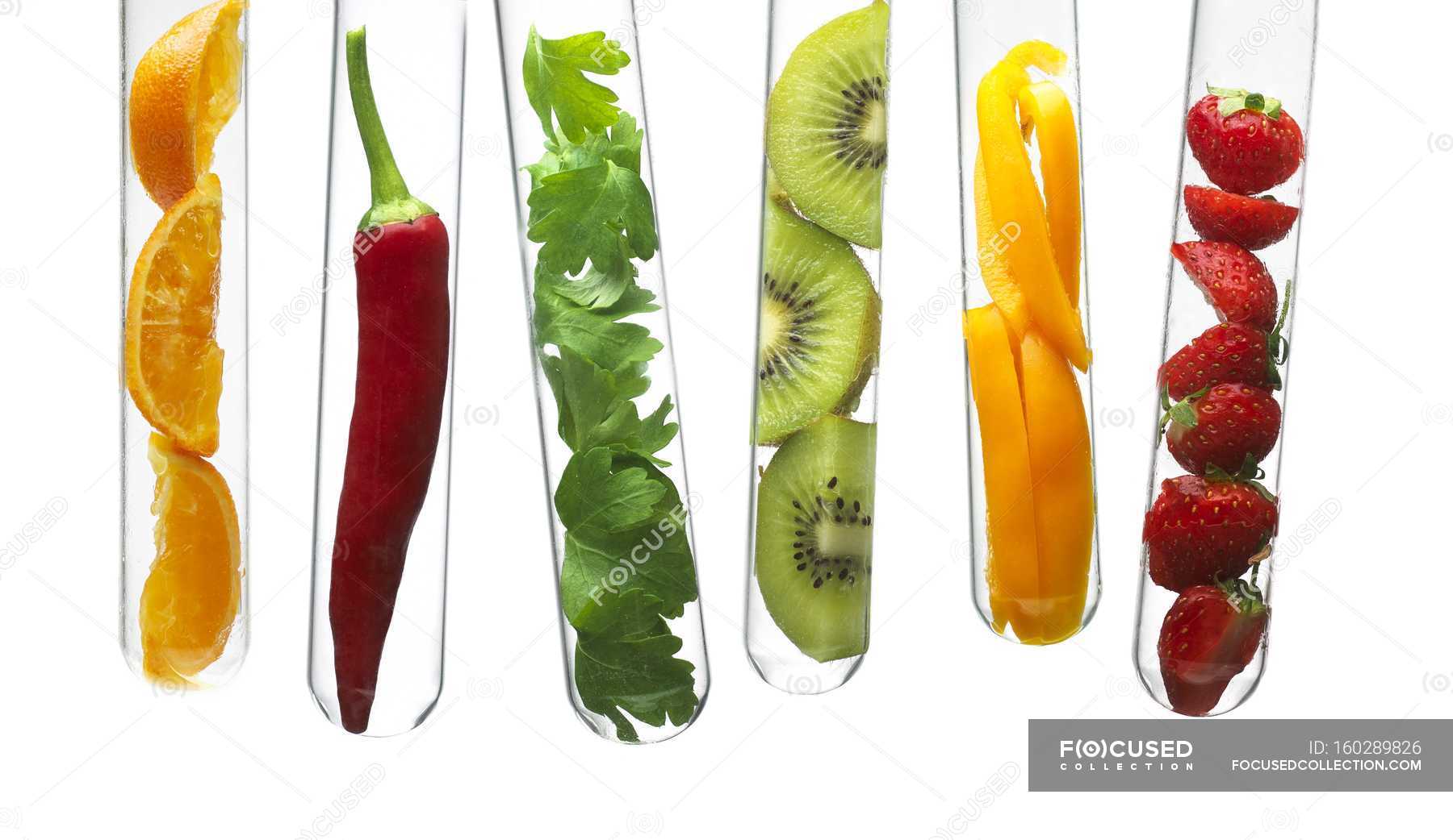 Fruits and vegetables in test tubes. — equipment, food Stock Photo