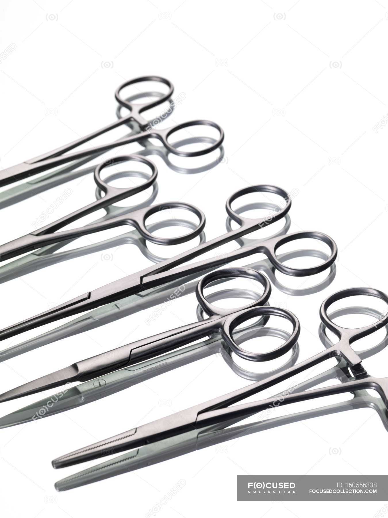 Surgical forceps on white background. — metal, medical instruments
