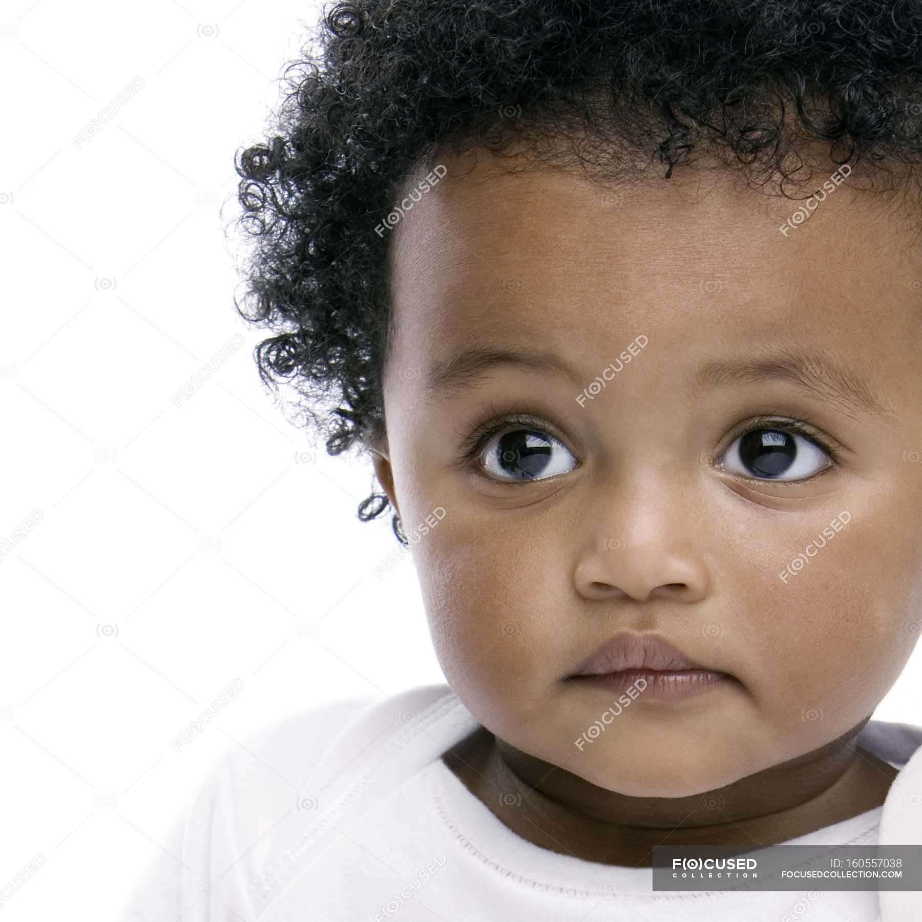 Portrait Of Baby Girl With Black Curly Hair Black Hair Head And Shoulders Stock Photo 160557038