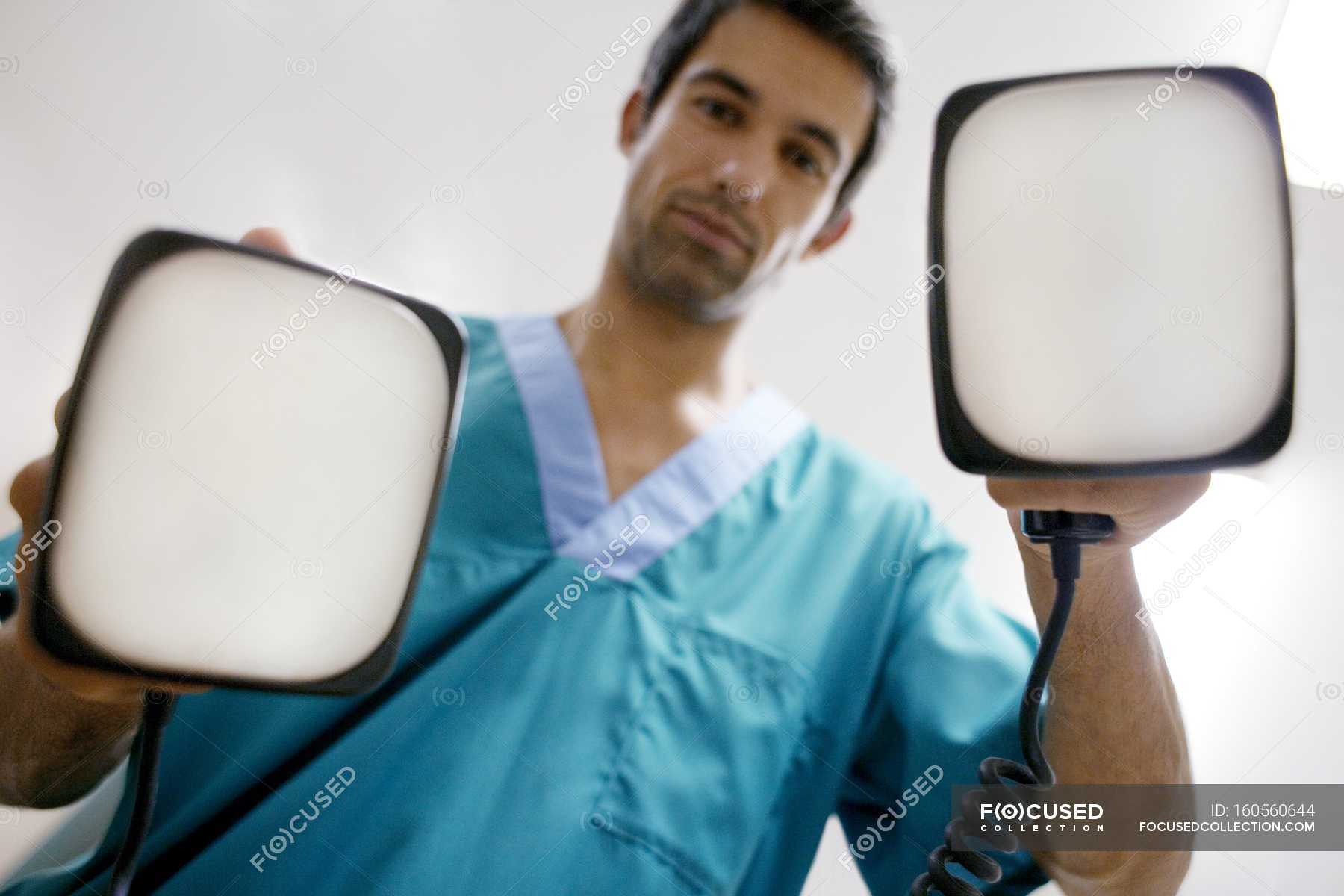 Doctor Holding Defibrillation Electrode Paddles Caucasian Ethnicity Equipment Stock Photo
