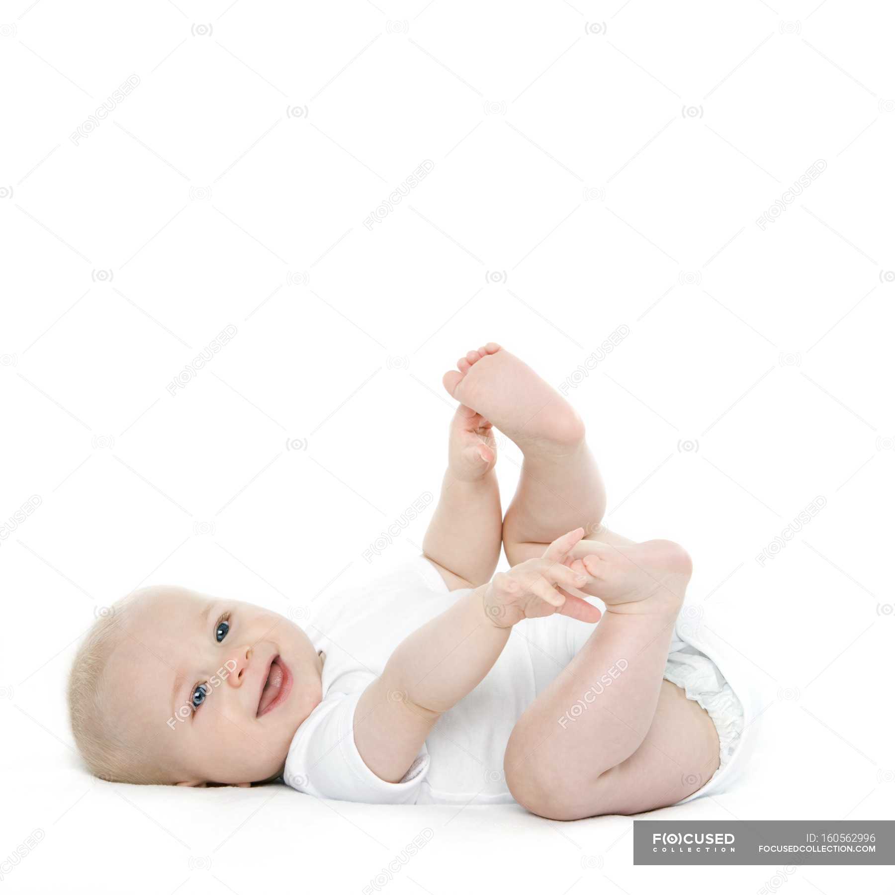 Baby Boy Lying On Back And Holding Feet — Cute Adorable Stock Photo