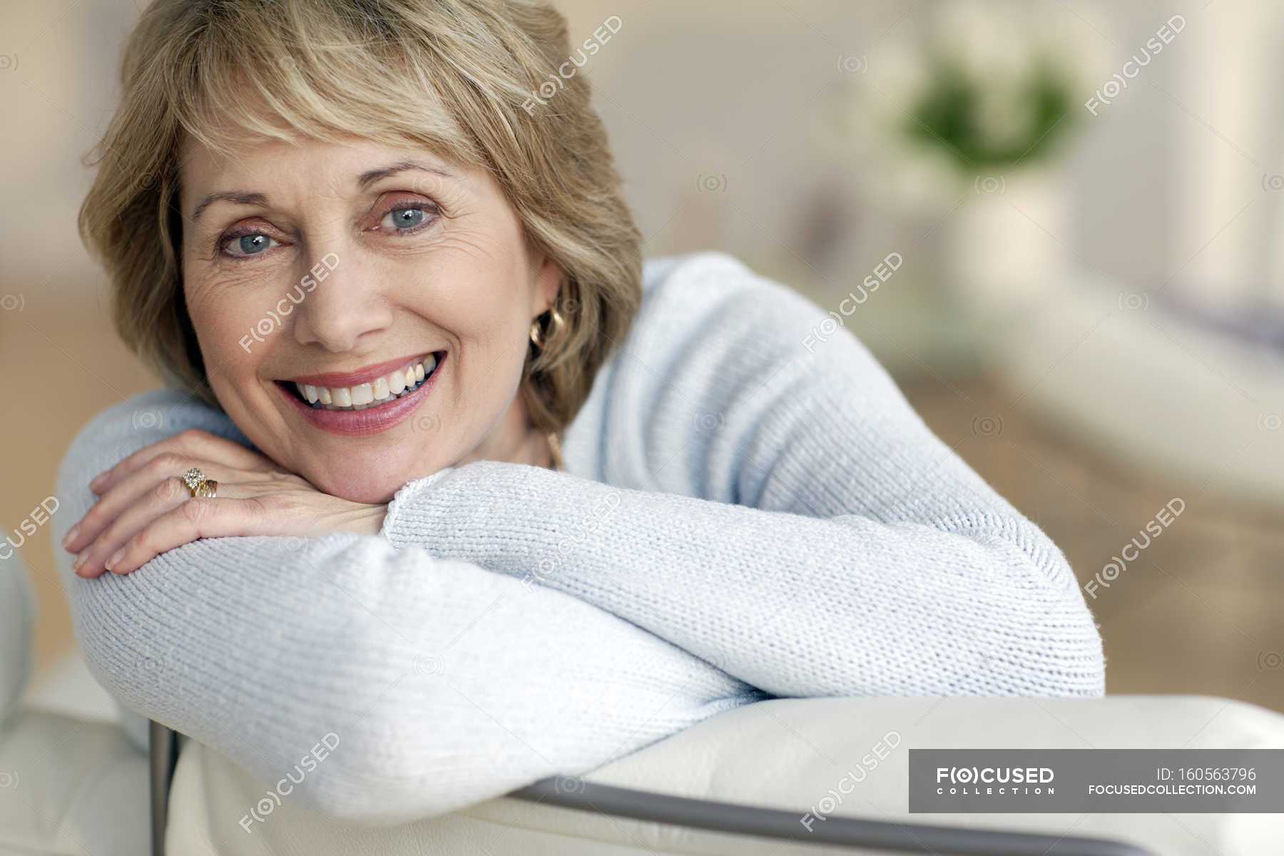 Attractive Mature Woman Smiling Looking Head In Hands Stock Photo My