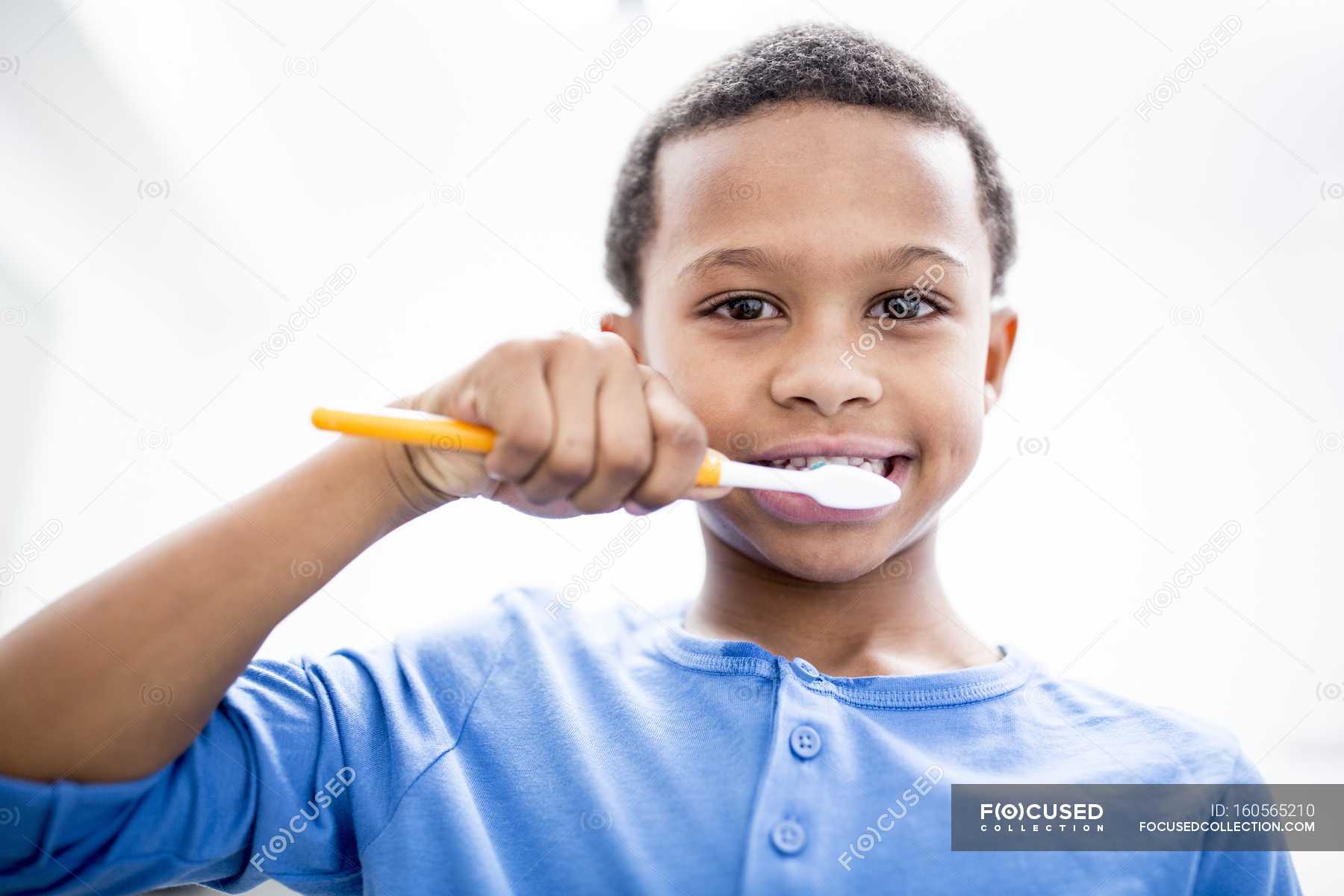 Portrait Of Boy Brushing Teeth On White Background — Medicine People