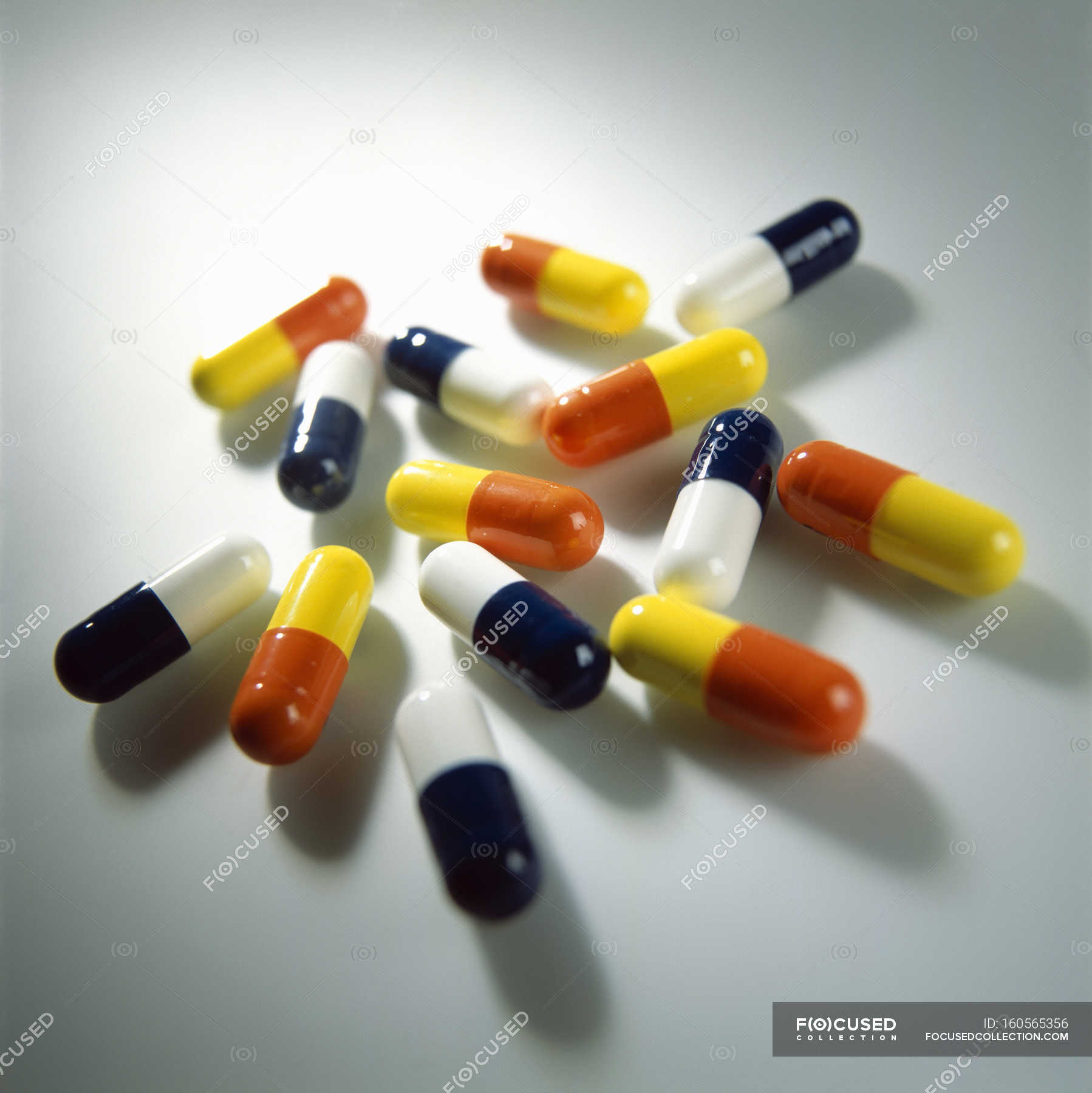Assorted brightly colored drug capsules. — multiple, healthcare Stock Photo 160565356