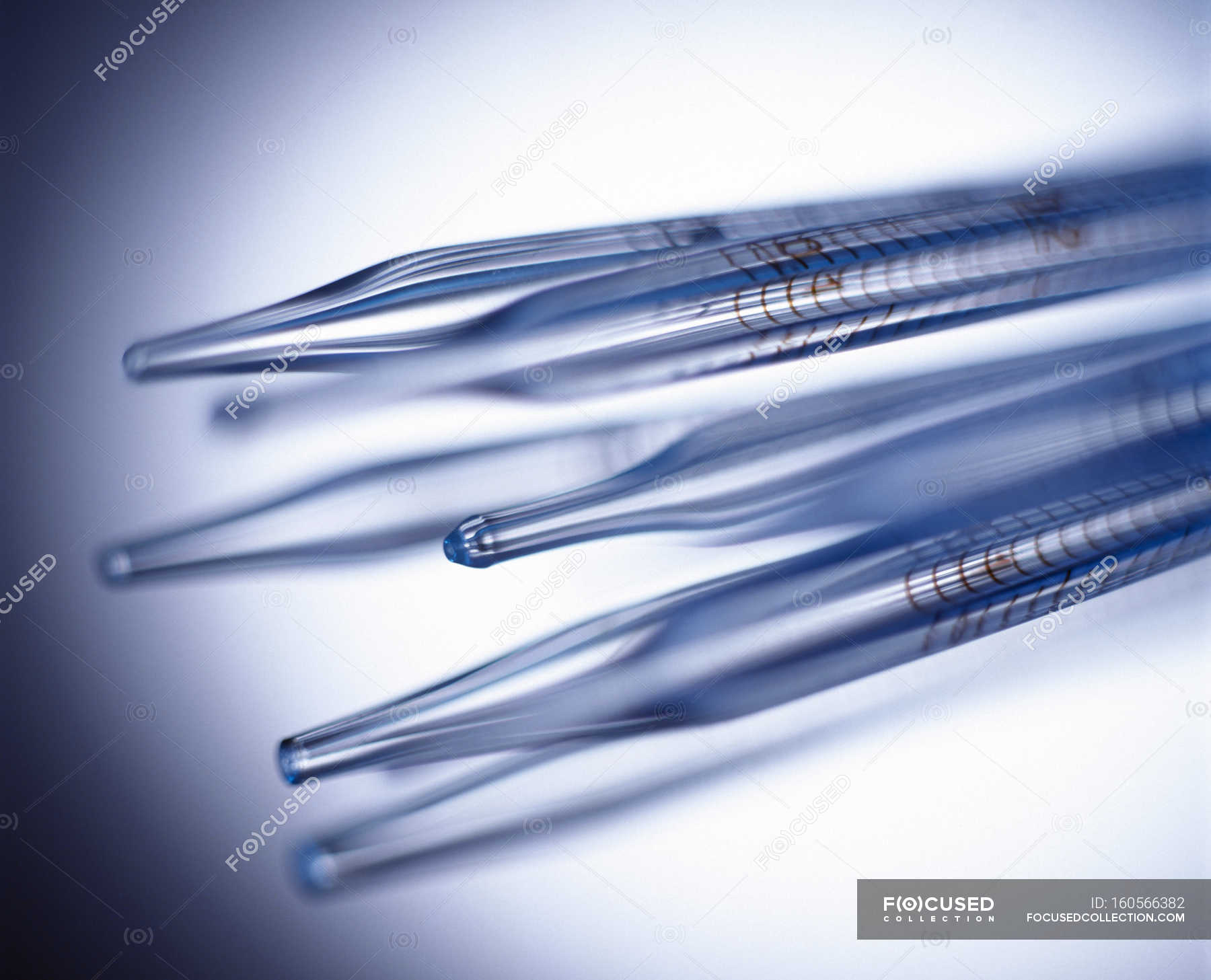 Standardized volume pipettes with bulbs, closeup. — measure
