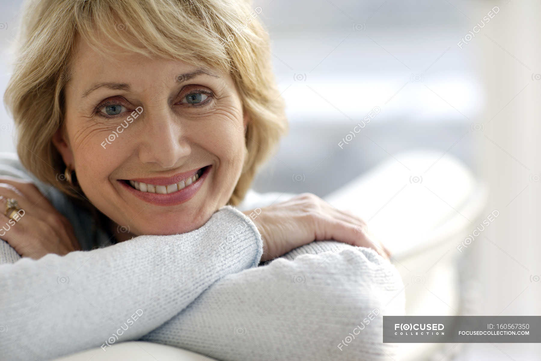 attractive-mature-woman-smiling-surface-fifties-stock-photo