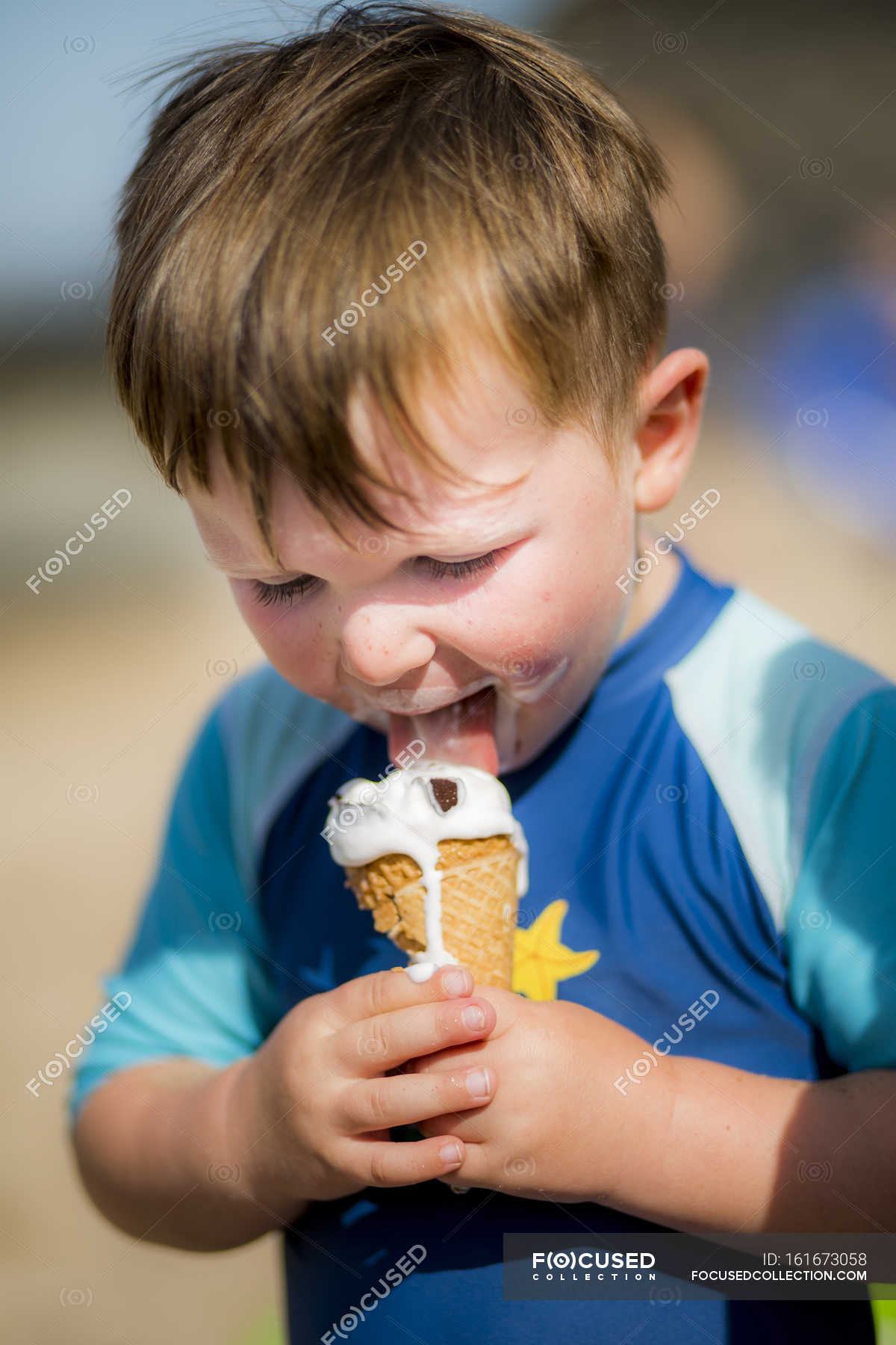 Toddler boy eating ice cream outdoors. — Front View, messy Stock