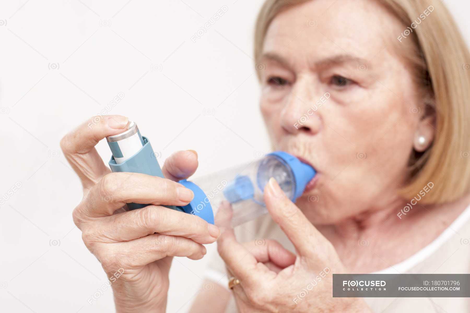 Senior woman using inhaler. — people, female - Stock Photo | #180701796