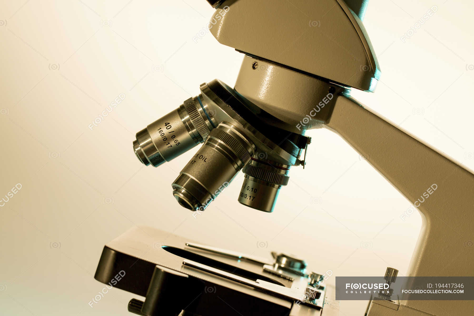 Closeup of light microscope stage and lenses. — optics, study Stock Photo 194417346