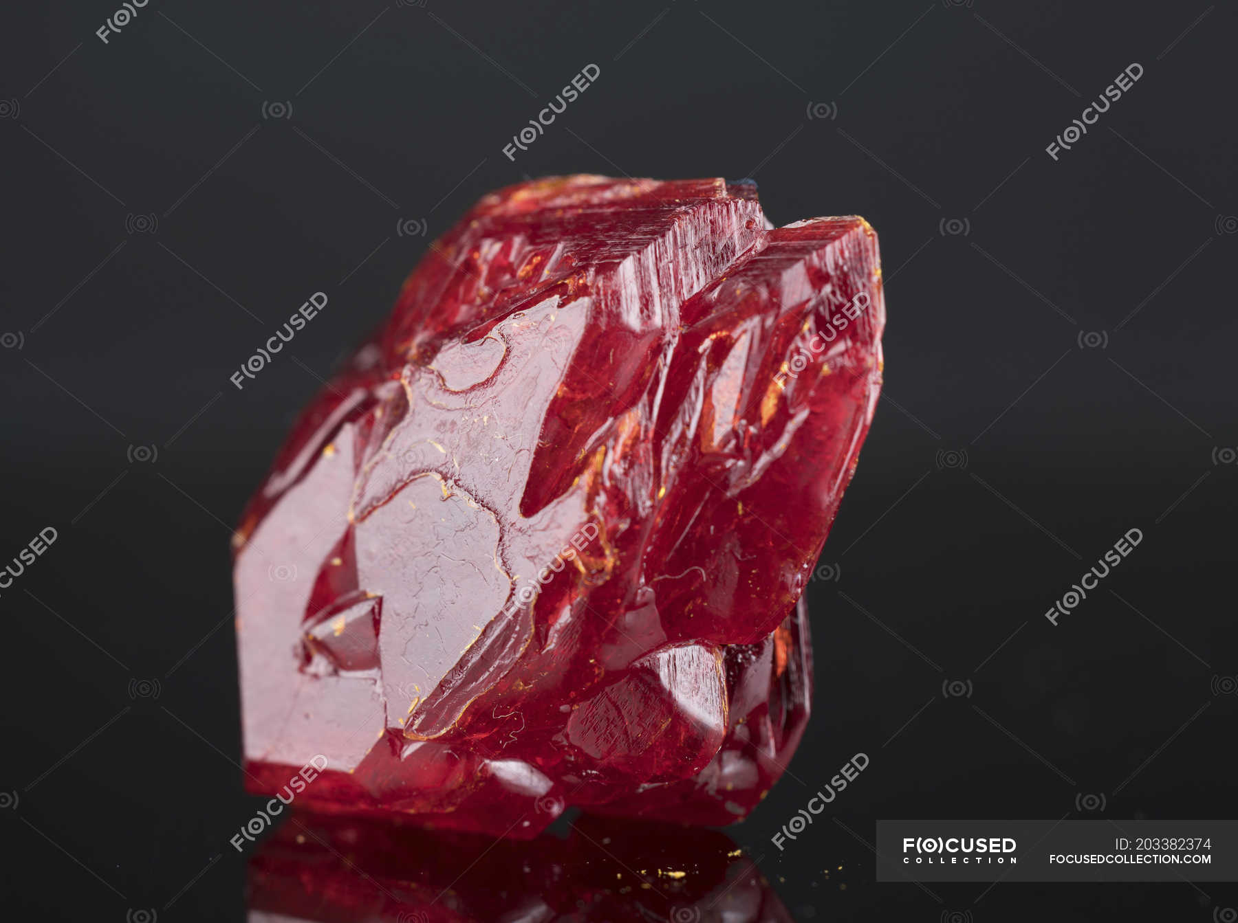 Red mineral gemstone on mirror surface. — gemmology, geological Stock