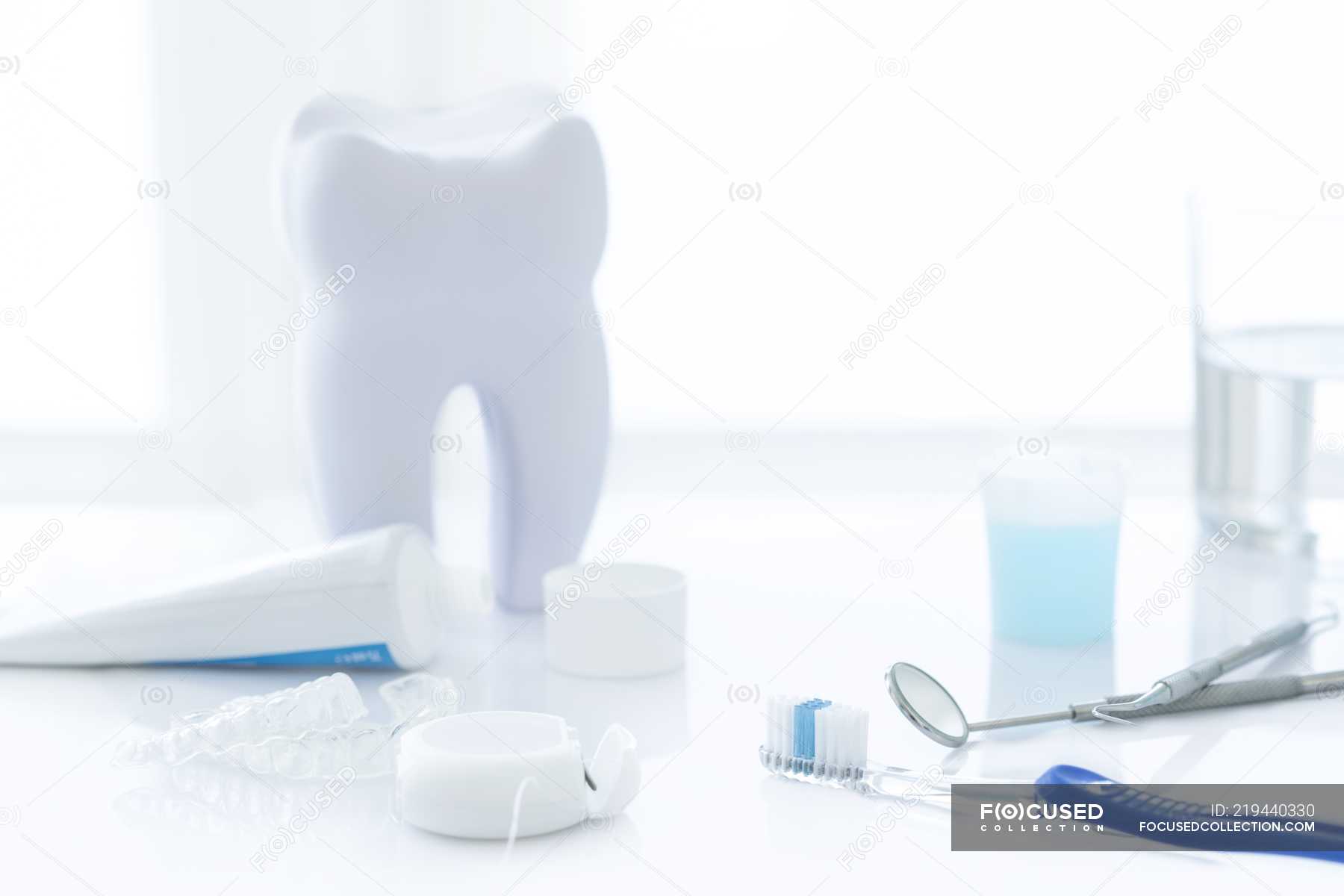 Dental clinic equipment and tooth model against white background. — still  life, dentist table - Stock Photo | #219440330