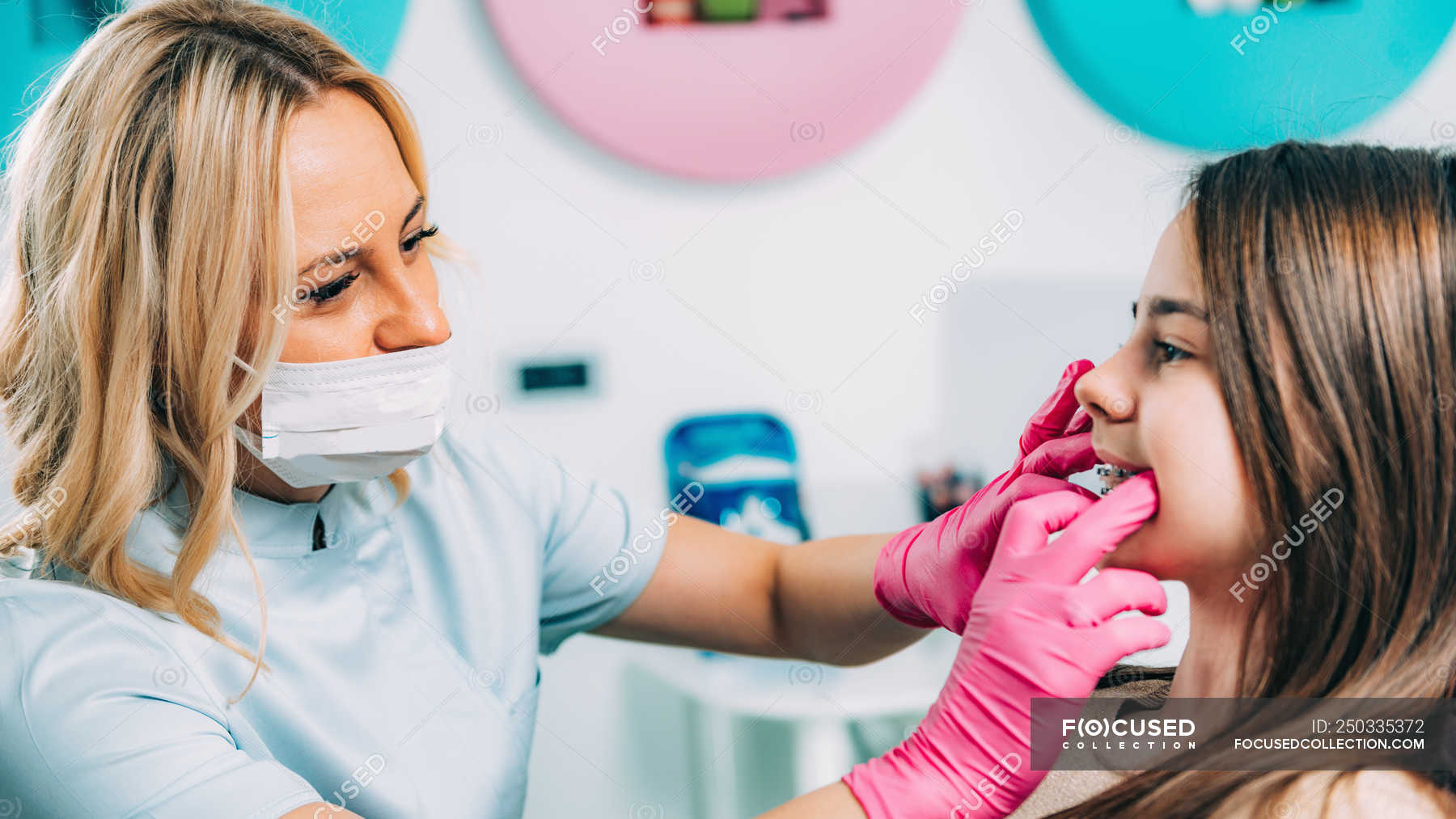 Female Orthodontist Fixing Dental Braces Of Girl In Clinic Dentistry female-orthodontist-fixing-dental-braces-of-girl-in-clinic-dentistry