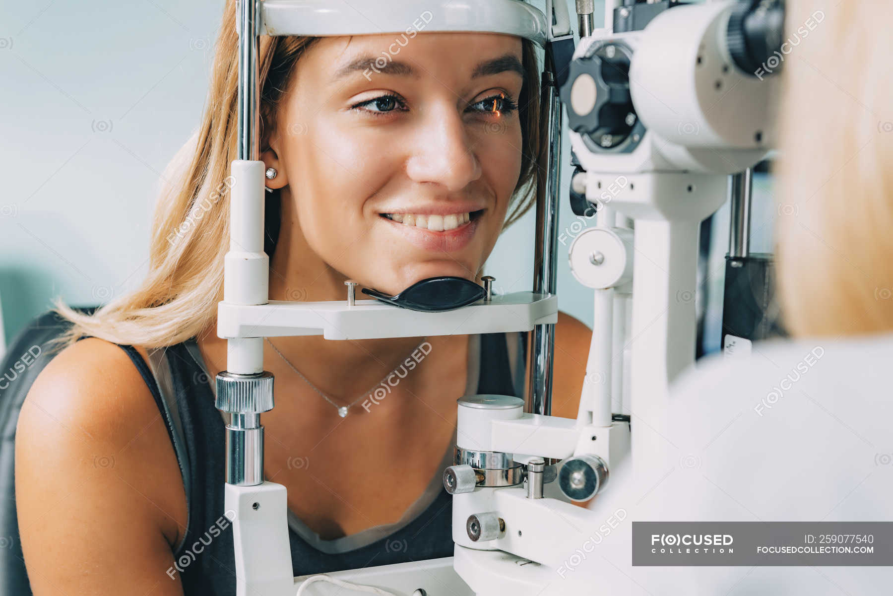 Patient undergoing applanation tonometry and eye pressure test in ...