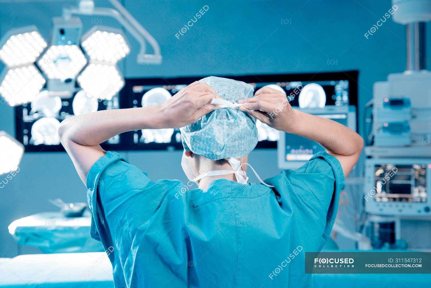 Surgeon gowning up, back view — mri, technology Stock Photo 311547312
