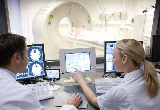 Radiographers taking computed tomography scan of patient. — Stock Photo
