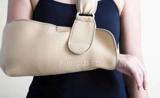 Cropped view of woman with arm in sling. — Stock Photo