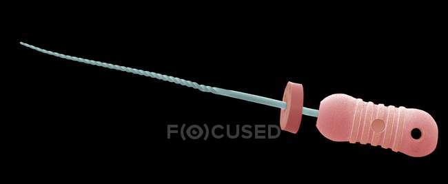 Coloured scanning electron micrograph (SEM) of a dental root canal file. — Stock Photo